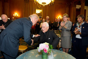 Vice President Joe Biden shakes hands with Father Hesburgh