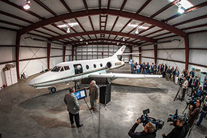 Dr. Eric Jumper, professor of aerospace and mechanical engineering, thanks Matthew McDevitt for the donation of a Falcon 10 during a news event at the South Bend Airport.