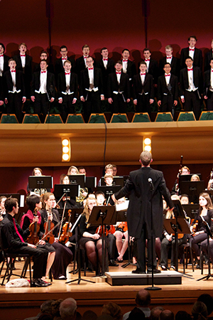 Dan Stowe conducts the NDSO during the combined NDSO/Glee Club Christmas concert in 2015