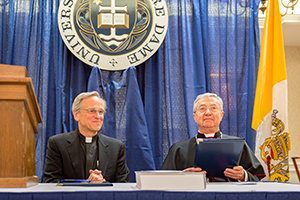 Rev. John I. Jenkins, C.S.C. (left), and Archbishop Jean-Louis Brugues, archivist and librarian of the Holy Roman Church, sign a memorandum of understanding for collaboration and exchanges between the Vatican Library and Notre Dame