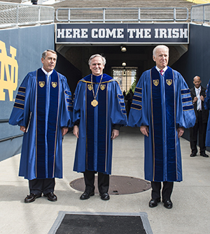 President Rev. John Jenkins, C.S.C., is flanked by Laetare Medal recipients John Boehner, former Speaker of the House (left), and Vice President Joe Biden before walking onto the stage for the 2016 Commencement Ceremony