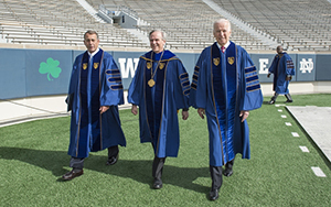 President Rev. John Jenkins, C.S.C., is flanked by Laetare Medal recipients John Boehner, former Speaker of the House, and Vice President Joe Biden before walking onto the stage for the 2016 Commencement Ceremony