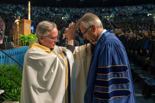Fr. Jenkins blesses Rev. Junge.