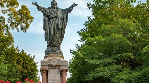 Sacred Heart Jesus statue on Main Quad with the inscription "Venite Ad Me Omnes" on the pedestal. Photo by Matt Cashore/University of Notre Dame