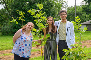 Student interns from the Center for Civic Innovation and Bowman Creek Educational Ecosystem, (names left-right) Annaliza Canda from Purdue University, Isaac Huston from Michigan State University and Tiffany Good from Indiana University SB stand in a native tree nursery that they helped plant and maintain on a former vacant lot in South Bend. Photo by Barbara Johnston/University of Notre Dame.