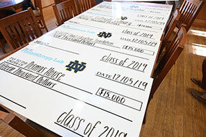 At an awards ceremony Dec. 5, the students presented novelty checks. Photo by Matt Cashore/University of Notre Dame.