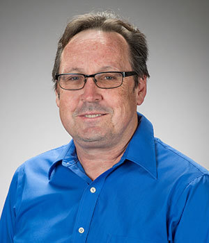 Male professor Dean Shepherd wearing blue shirt