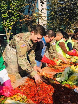 Josh Korhorn performing volunteer work at a local charity food drive while in Korea