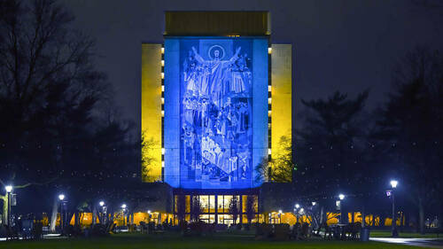The Hesburgh Library Word of Life Mural is lit in the colors of the Ukrainian flag in solidarity with the people of Ukraine. (Photo by Matt Cashore/University of Notre Dame)