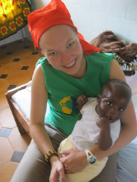 Marta Michalska holds a child at an orphanage in Tanzania