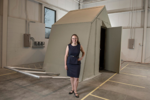 Ashley Thrall with the origami shelter in the Ave Maria Press building