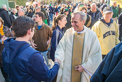 Rev. John Jenkins, C.S.C., shakes hands after the Shamrock Series Mass at Holy Cross Cathedral in Boston