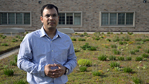 Postdoctoral researcher Ashish Sharma stands on a green roof