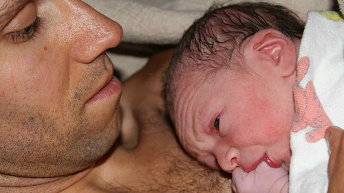Professor Lee Gettler holds his newborn son