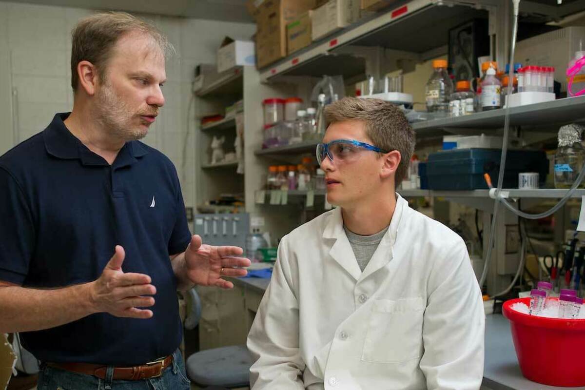 Jeff Schorey talks with an undergraduate researcher. Photo by Matt Cashore/University of Notre Dame.