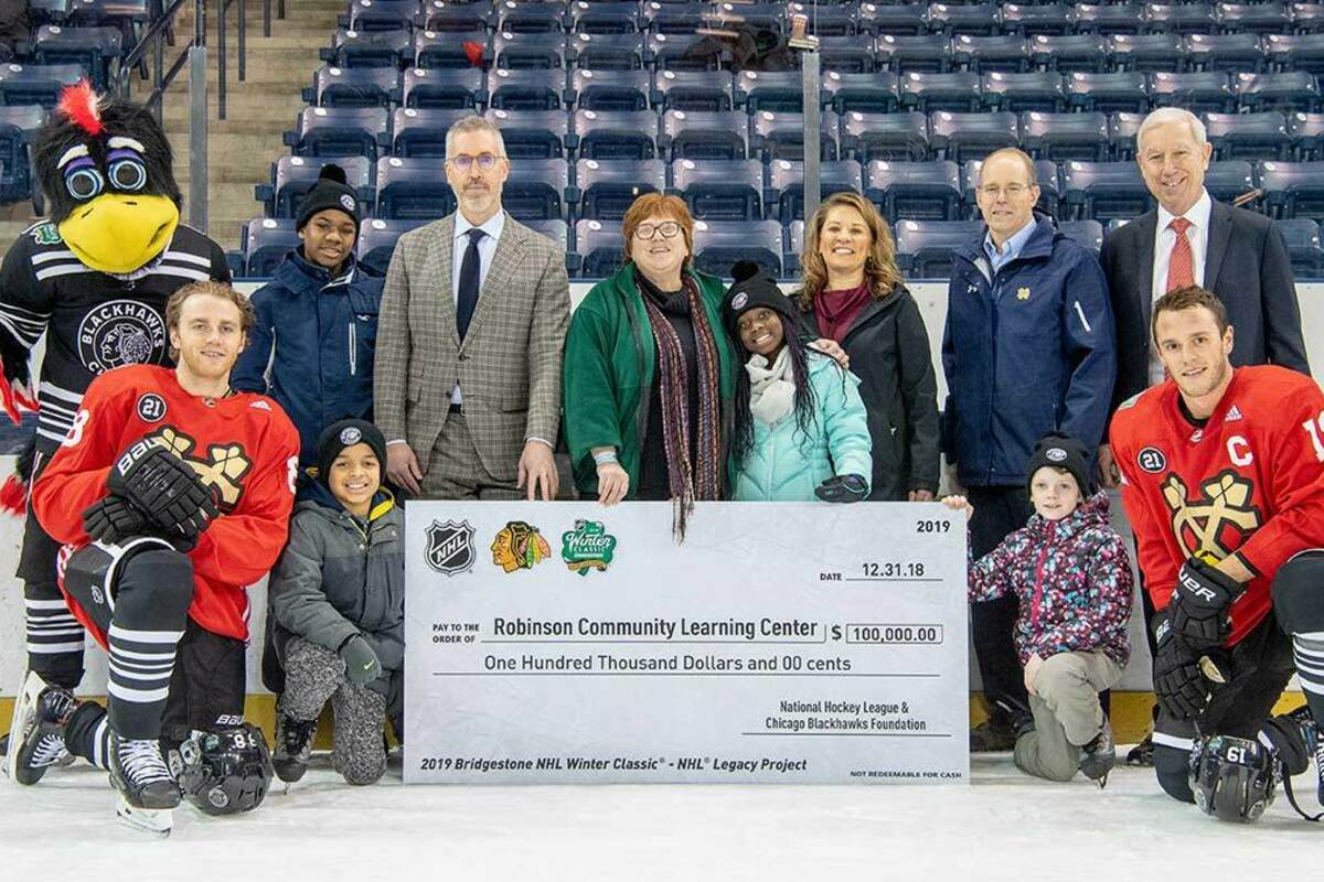 Robinson Community Learning Center staff and students pose for a photo with representatives from the Chicago Blackhawks.