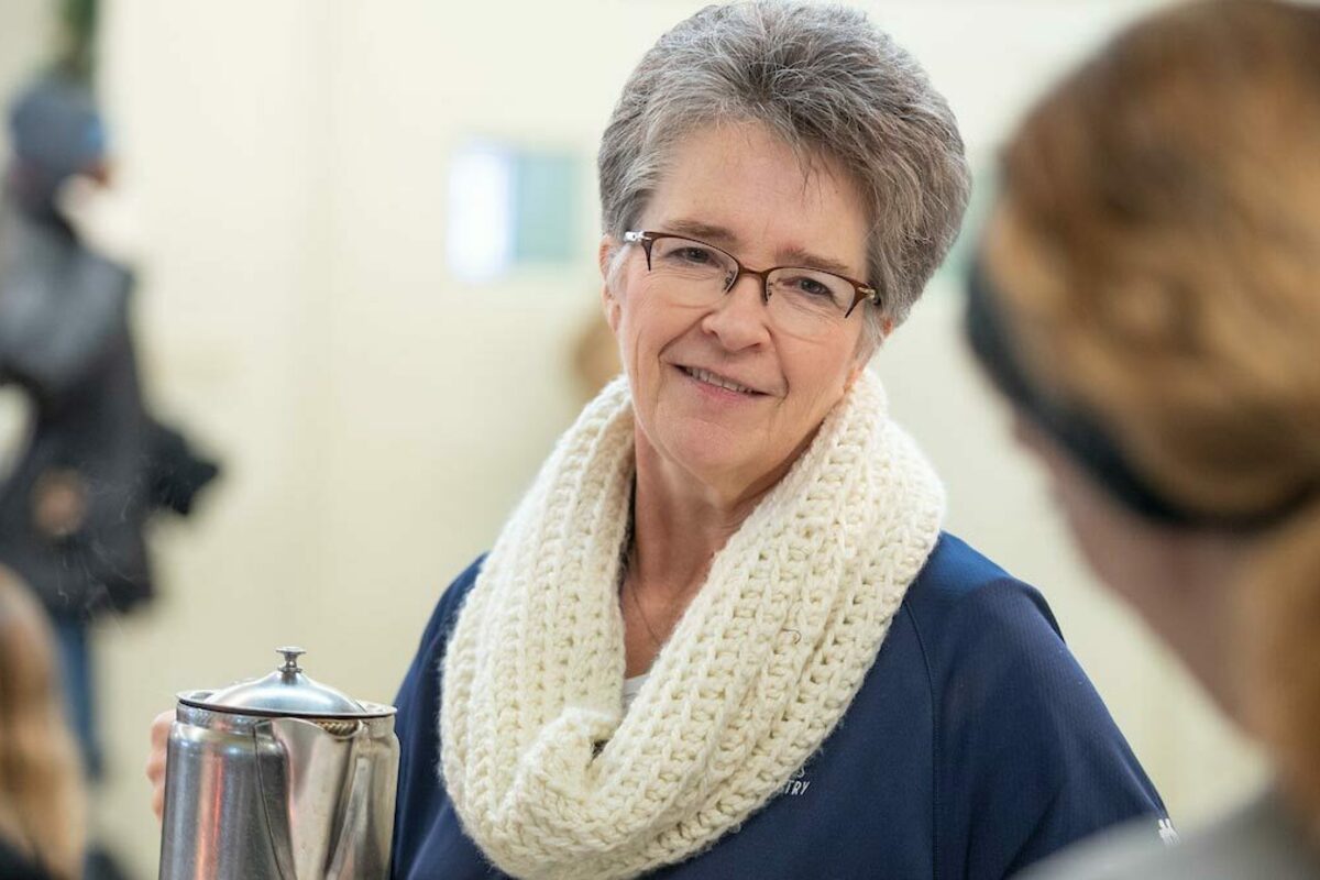 Nancy Beitler serves coffee at Our Lady of the Road in South Bend. Photo by Matt Cashore/University of Notre Dame.
