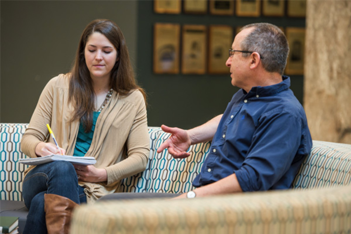 Doctoral student Anna Fett talks with Asher Kaufman, professor of history and the John M. Regan Jr. Director of the Kroc Institute