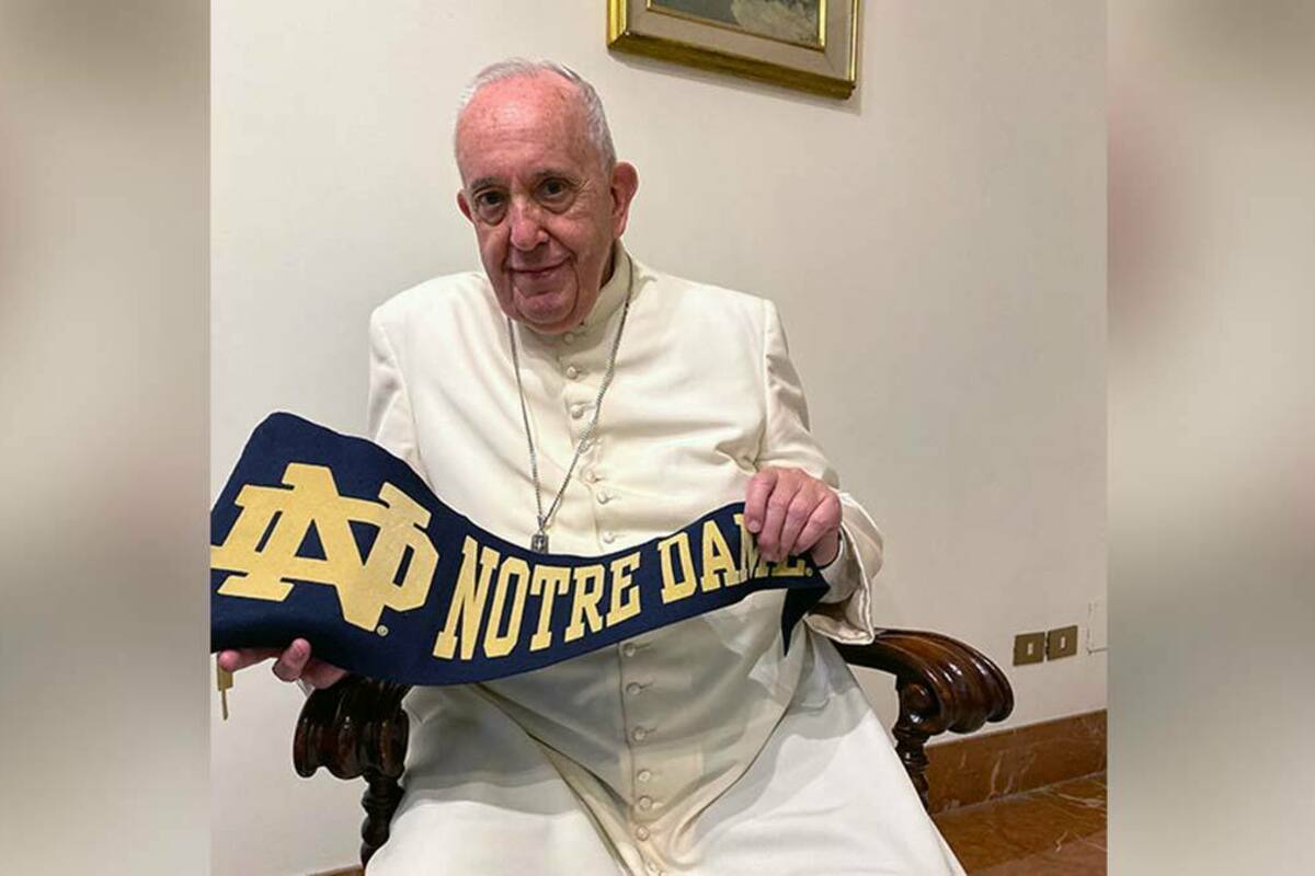 Pope Francis displays a Notre Dame pennant.
