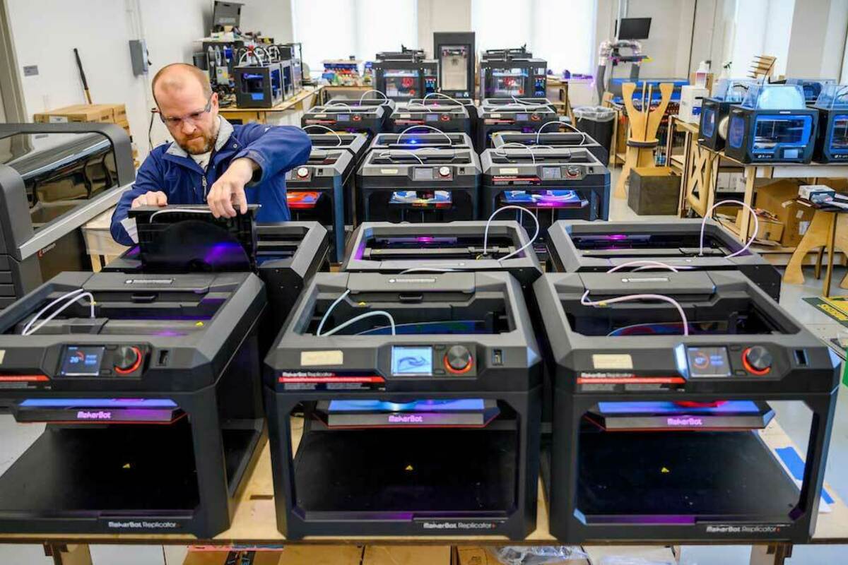 Professor Matt Leevy checks a 3D printer in the Innovation Lab at the IDEA Center. Photo by Barbara Johnston/University of Notre Dame.