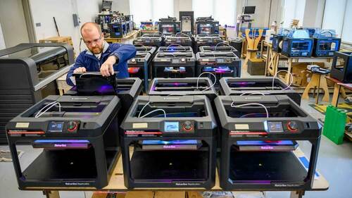Professor Matt Leevy checks a 3D printer in the Innovation Lab at the IDEA Center. Photo by Barbara Johnston/University of Notre Dame.