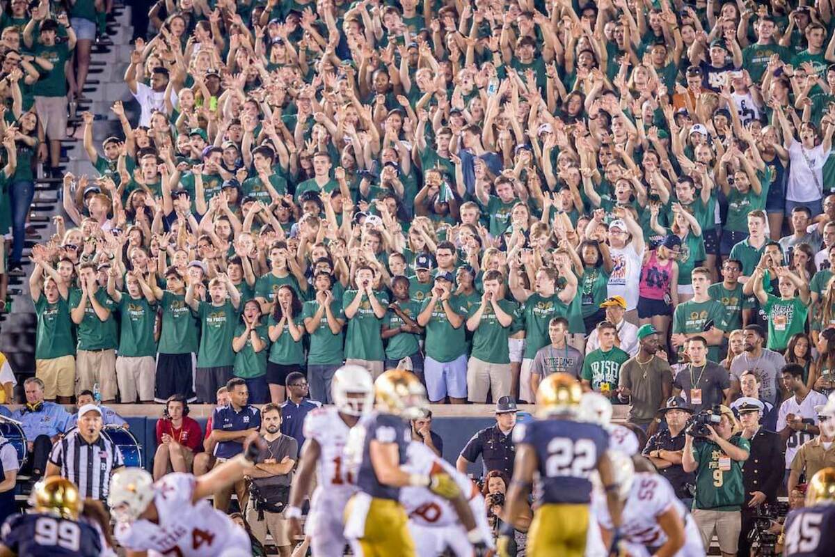 Student section wearing The Shirt during a football game. Photo by Matt Cashore/University of Notre Dame.
