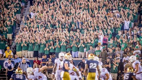 Student section wearing The Shirt during a football game. Photo by Matt Cashore/University of Notre Dame.