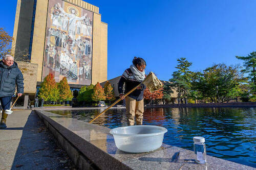 Graduate students in Ron Hellenthal's Aquatic Insects class take samples of insects from the library reflecting pool on the day it is drained for the year. Photo by Matt Cashore/University of Notre Dame.