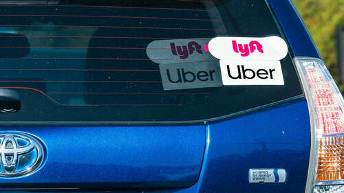 A car driving for Uber and Lyft.
