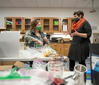Assistant Professor of Anthropology Cara Ocobock (right) and PhD student Hannah Wesselman chat in the lab where the kits were assembled.