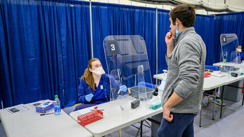 Student EMT Katie Steenvoorden ’21, watches as Andrew Seketa ’21 gets a sample for testing in the nasal swab testing area of the University's COVID testing facility in the Joyce Center. (Photo by Matt Cashore/University of Notre Dame)