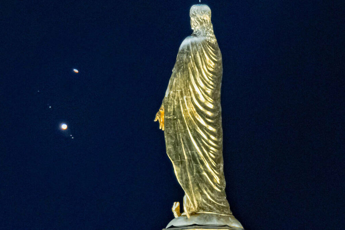 The planets Saturn (top) and Jupiter (with Galilean moons visible) seen behind the Mary statue on the Golden Dome. The orbits of the two planets overlap and visually appear to nearly merge in what is known as The Great Conjunction. NOTE: Photo is a composite of two images for purposes of having both the statue and planets in focus, which is not possible in a single exposure. (Photo composite by Matt Cashore/University of Notre Dame)