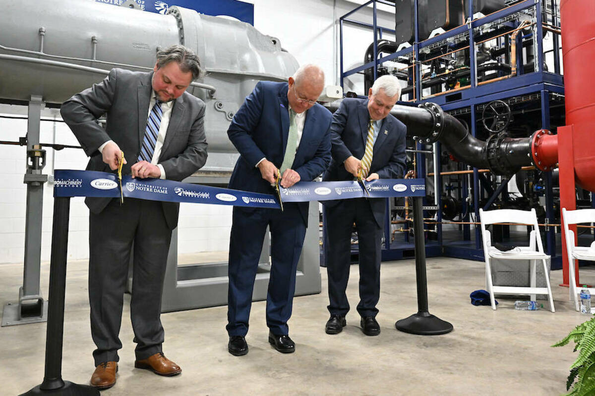 From left to right: Joshua Cameron, director of the Notre Dame Turbomachinery Laboratory, Chris Kmetz, senior vice president, engineering, for Carrier and Bob Bernhard, University of Notre Dame vice president for research cut the ribbon on the Willis Carrier Centrifugal Compressor Technology Laboratory at the Notre Dame Turbomachinery Lab in South Bend. (Photo by Matt Cashore/University of Notre Dame)