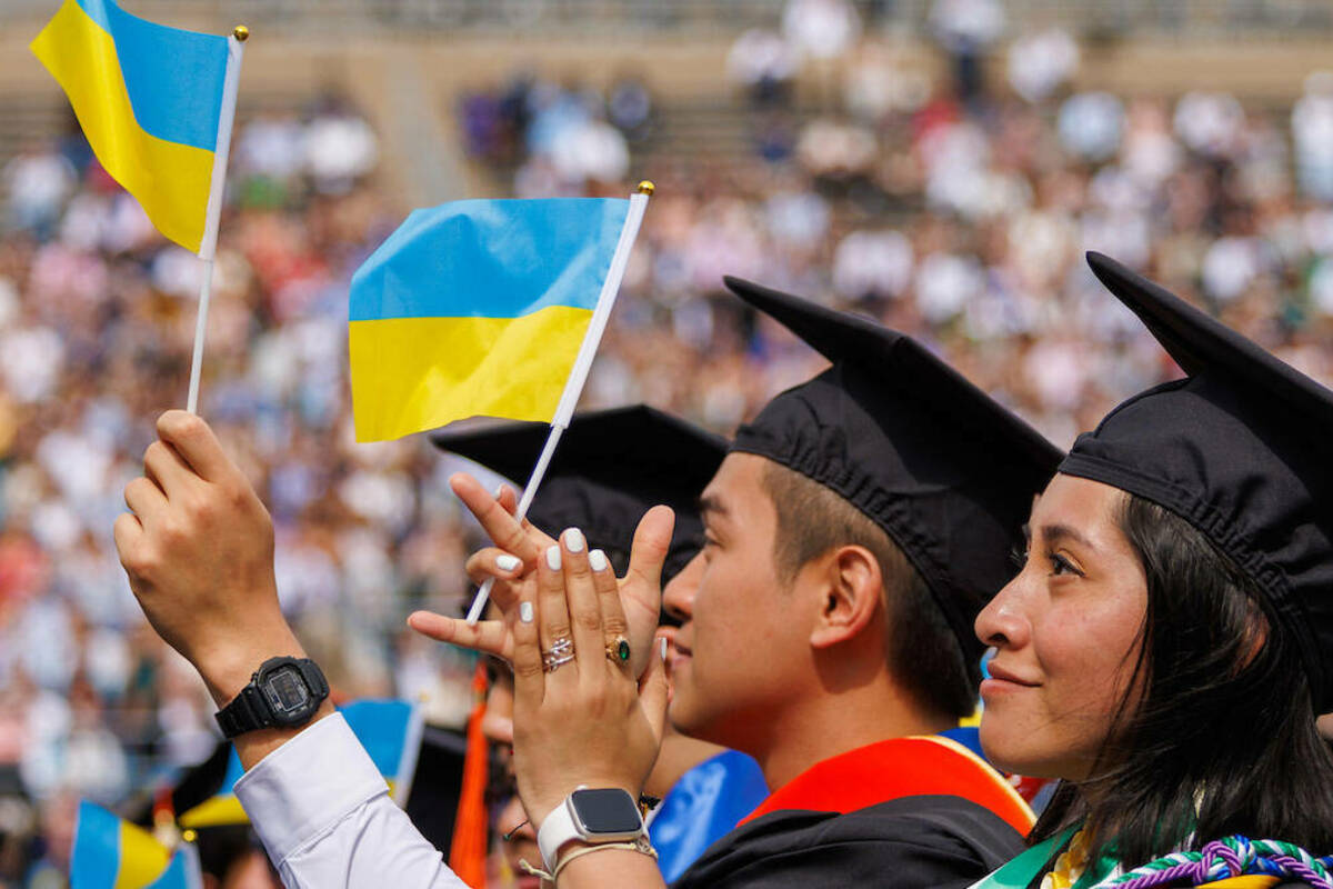 Students wave Ukrainian flags as a tribute to Commencement speaker Archbishop Borys Gudsiak. (Photo by Peter Ringenberg/University of Notre Dame)