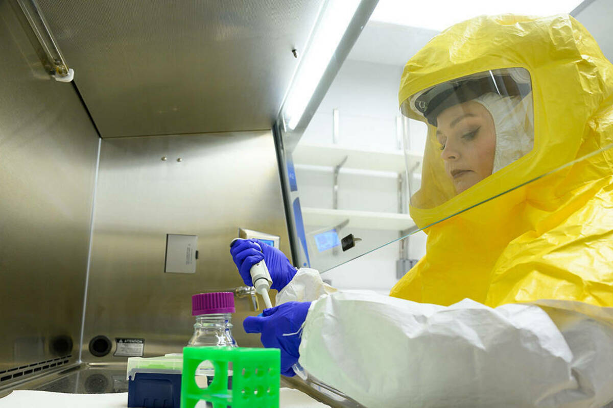 Ph.D. student Kathleen Nicholson demonstrates the biosafety level 3 facility. (Photo by Matt Cashore/University of Notre Dame)