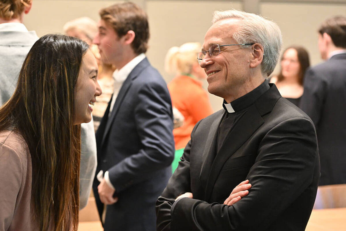 Notre Dame President Rev. John I. Jenkins, C.S.C. chats with students in the political science course "Philanthropy: Society and the Common Good" during a semester-end event. (Photo by Matt Cashore/University of Notre Dame)