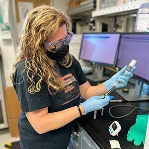 Melissa Berke works with a core sample in a lab on the JOIDES research vessel.