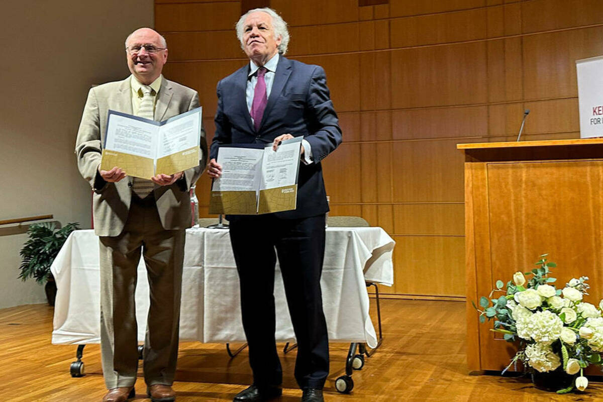 From left, Scott Appleby, Marilyn Keough Dean of the University of Notre Dame’s Keough School of Global Affairs, and Organization of American States Secretary General Luis Almagro celebrate the announcement of a new partnership to protect human rights and democracy.