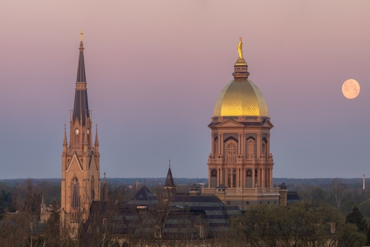 The nearly full moon shines over the Golden Dome and Basilica.