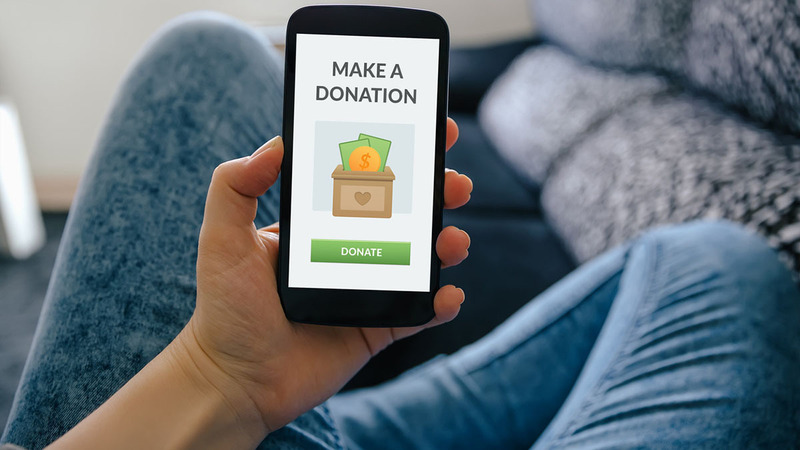 Person making an online donation from a smartphone