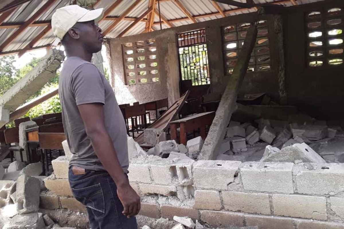 A responder surveys damage following Haiti’s 2021 earthquake.