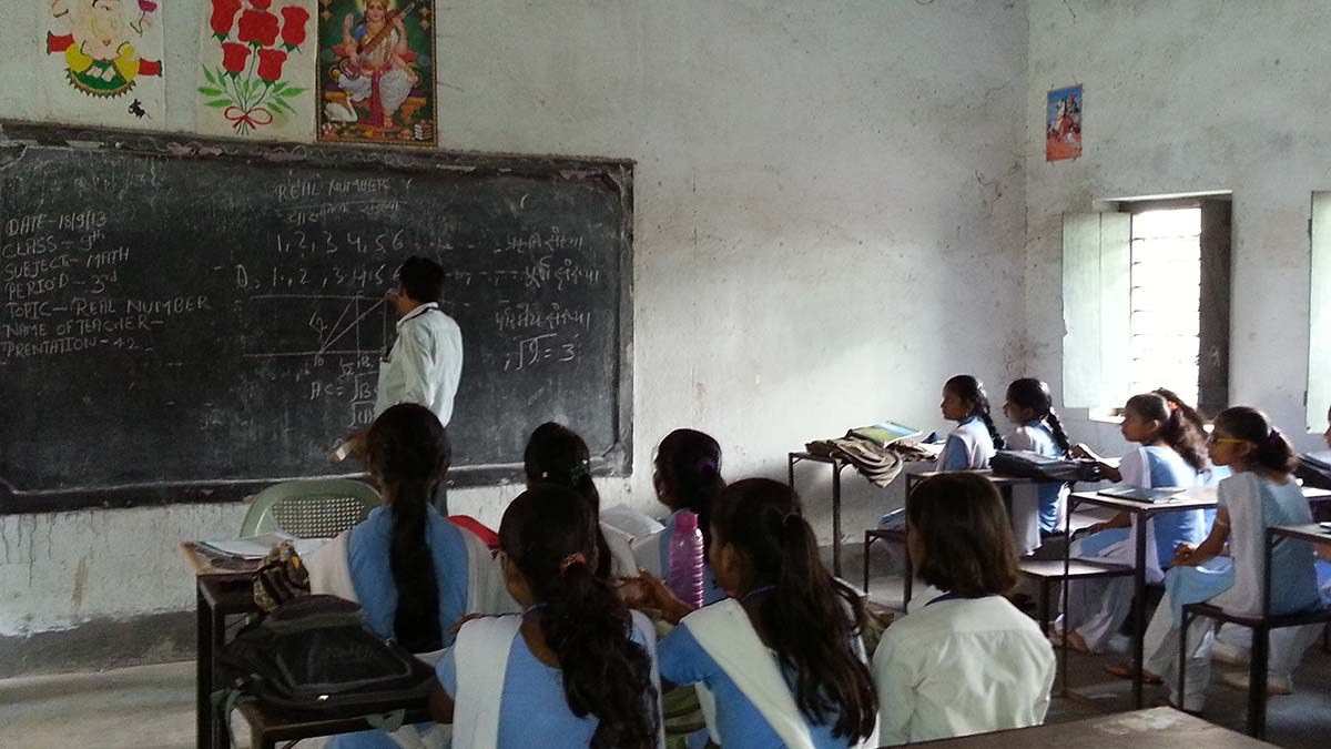 A math teacher explains concepts to a high school class in Hajipur, India. Photo by TESS-India via Flickr.