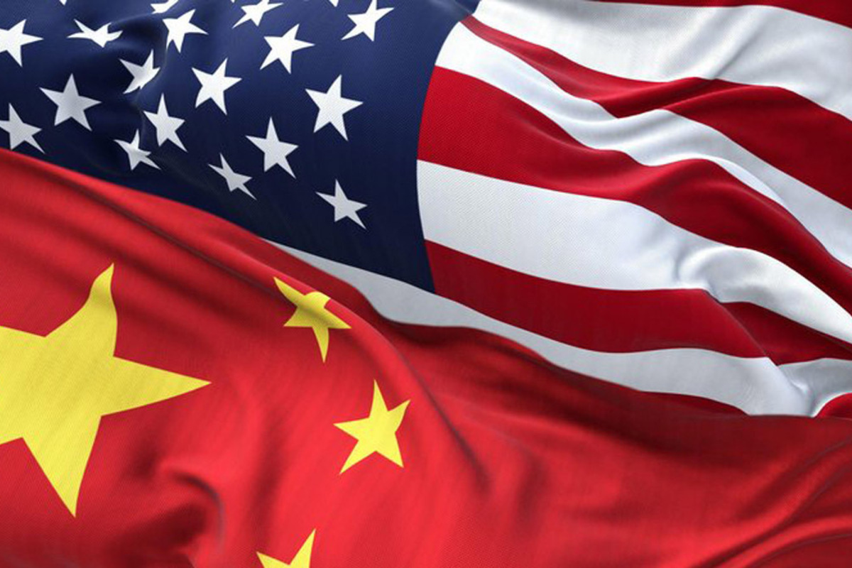A graphic depicts the U.S. and Chinese flags enmeshed and merging in the middle where they overlap, representing U.S.-China relations.