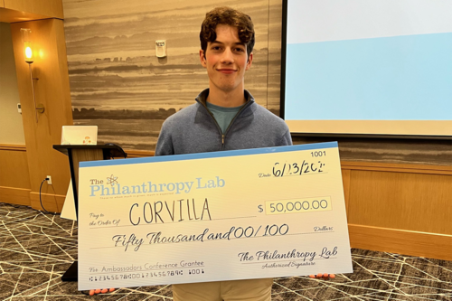 A young man holding a novelty check.