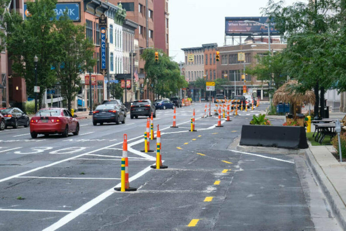 An interim road plan along Michigan Avenue in Kalamazoo, Michigan, features three lanes of one-way traffic with an added bike lane.