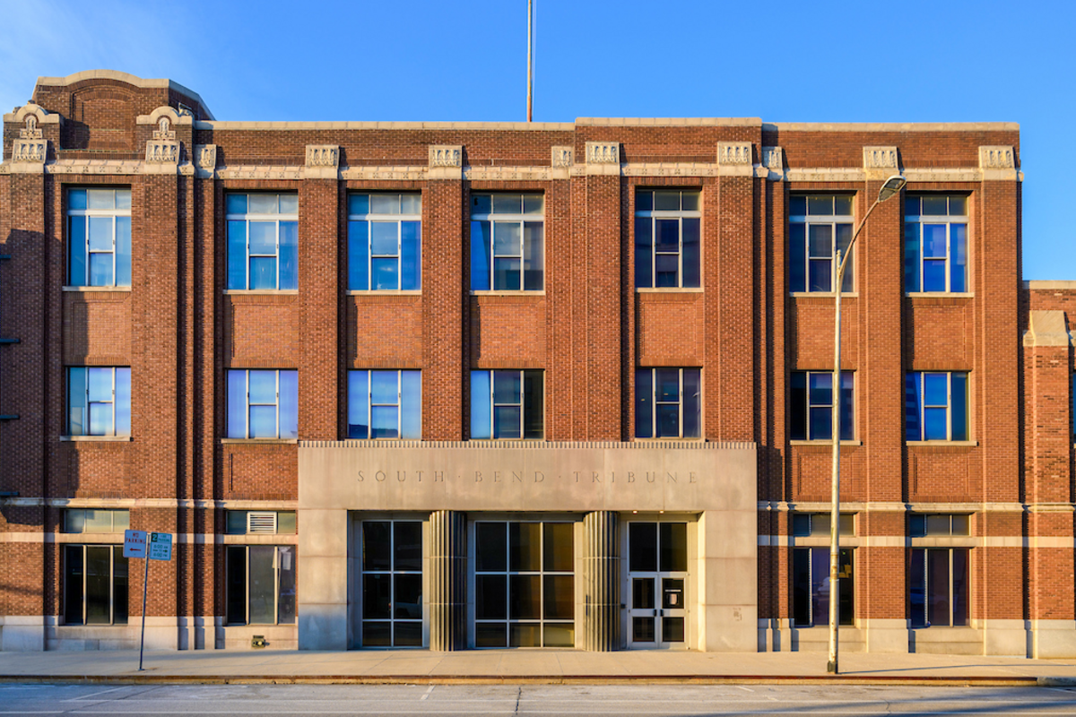 Facade of brick newspaper building.