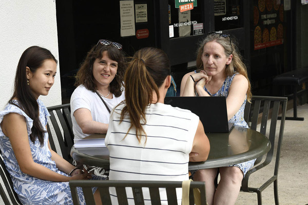 Table with 4 ladies seated discussing the August 8 fire in Lahaina (including Professor Ostermann)