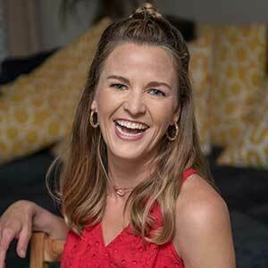 Kate Biberdorf is pictured, seated and smiling.